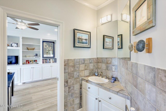 205 Audubon Point Dr, Brandon, MS 39047 - bathroom featuring vanity, ornamental molding, wood finished floors, tile walls, and ceiling fan