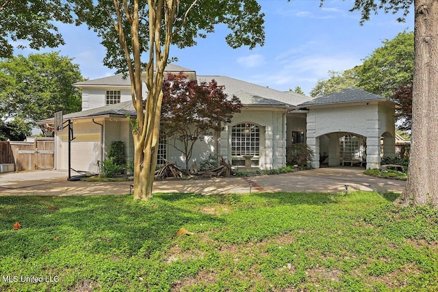 205 Audubon Point Dr, Brandon, MS 39047 - view of front of house featuring a garage, fence, a front yard, and concrete driveway
