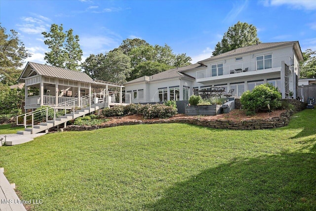 205 Audubon Point Dr, Brandon, MS 39047 - back of property featuring stairway, a lawn, and a sunroom