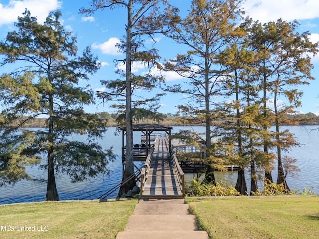 dock featuring a water view and a lawn