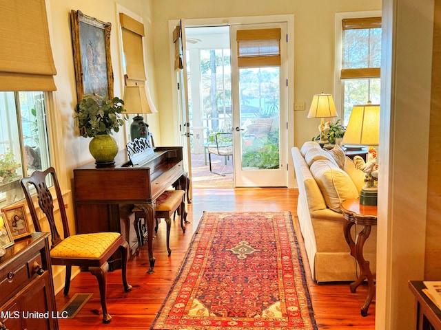 doorway to outside featuring french doors, a wealth of natural light, and light wood-type flooring