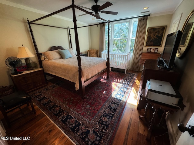 bedroom featuring ornamental molding, hardwood / wood-style floors, and ceiling fan