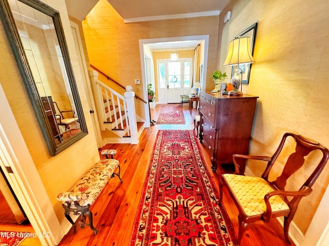doorway featuring wood finished floors and stairs