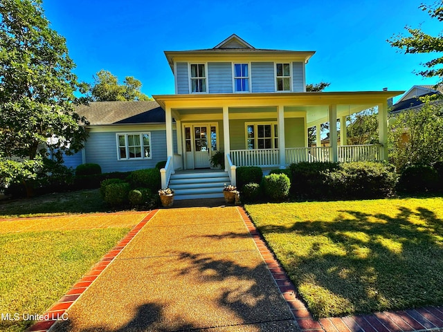 view of front of home with covered porch and a front lawn