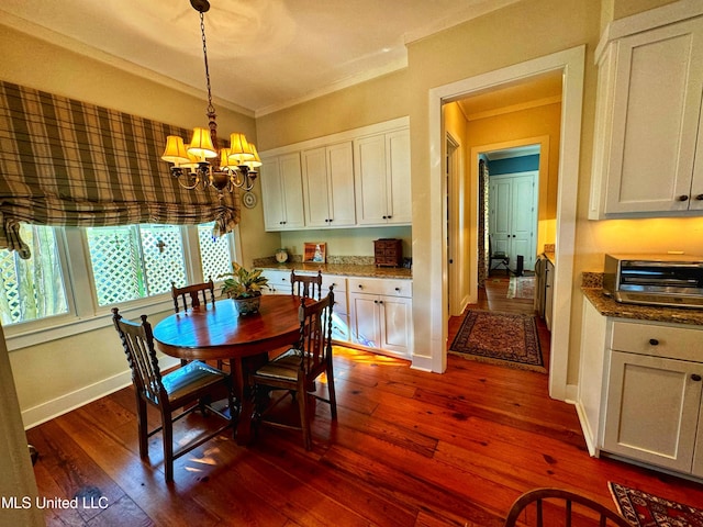 dining space featuring a chandelier, dark wood-style flooring, ornamental molding, and baseboards
