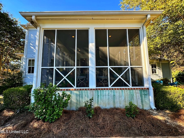back of property featuring a sunroom