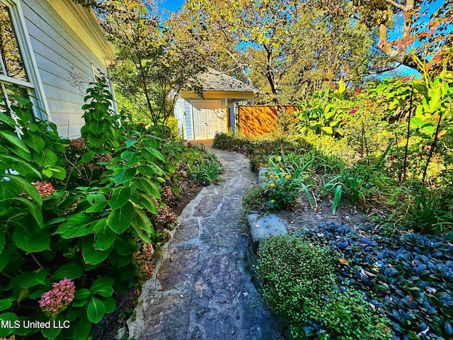 view of yard with fence and an outbuilding