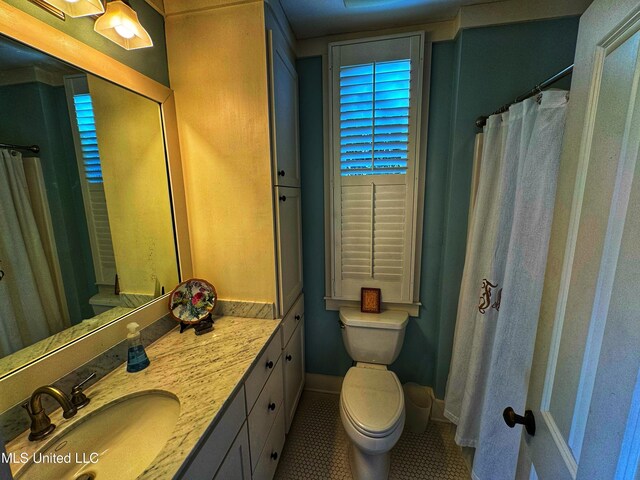 bathroom with vanity, toilet, baseboards, tile patterned floors, and a shower with shower curtain