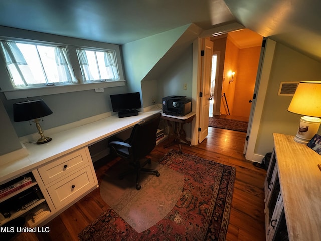 home office with dark wood-type flooring, built in desk, and lofted ceiling