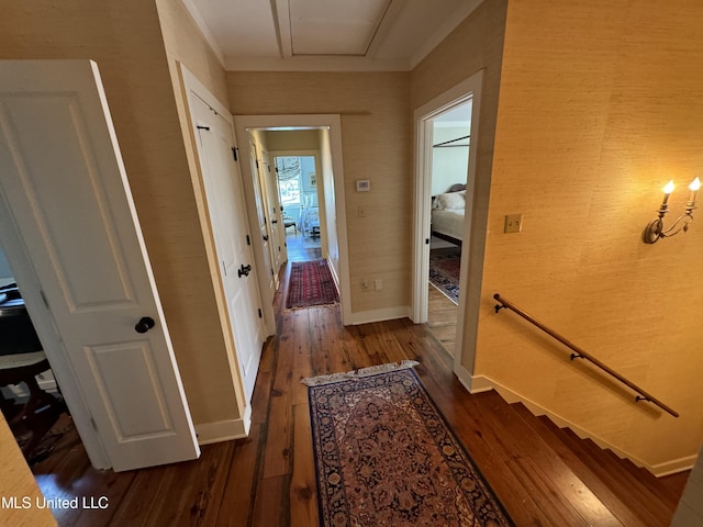 hallway featuring dark wood finished floors and baseboards