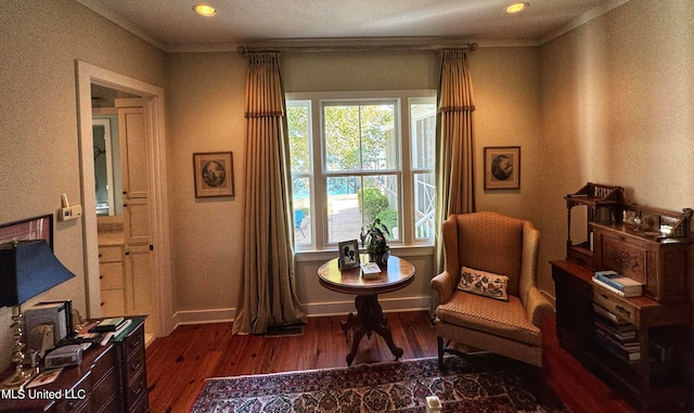 living area with dark wood-type flooring, crown molding, and a textured ceiling