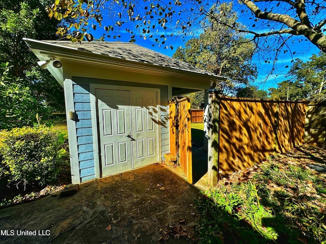 view of shed featuring fence