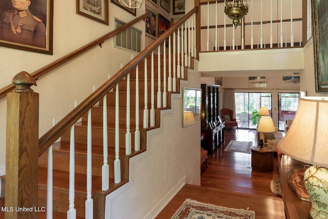 144 Gum Branch To Highway 25 Road, Louisville, MS 39339 - staircase with a textured wall, wood finished floors, a high ceiling, and baseboards