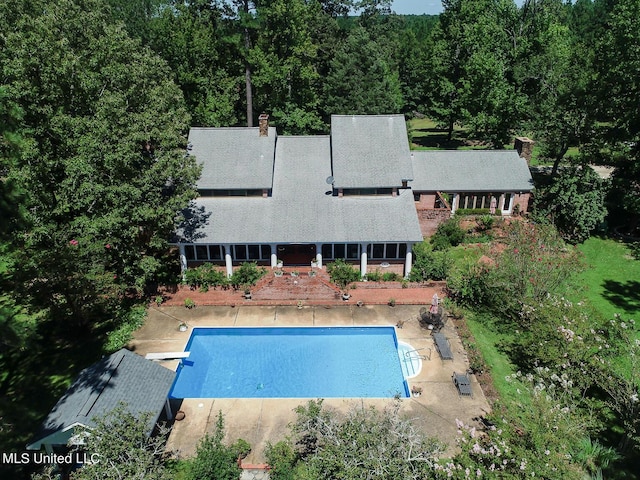 144 Gum Branch To Highway 25 Road, Louisville, MS 39339 - rear view of property featuring a patio area, an outdoor pool, and a chimney