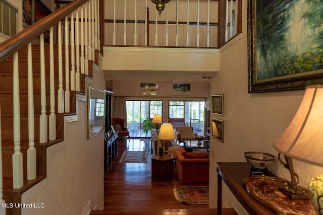 144 Gum Branch To Highway 25 Road, Louisville, MS 39339 - hallway with wood finished floors, a textured wall, a high ceiling, and stairs