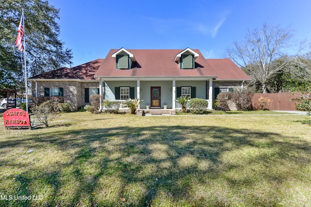 cape cod-style house featuring a porch, fence, and a front lawn