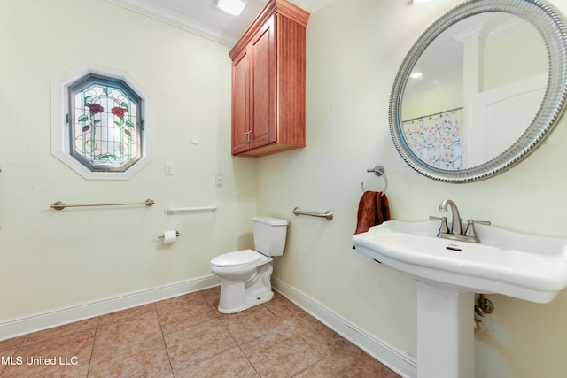 full bath featuring toilet, a sink, baseboards, tile patterned floors, and crown molding