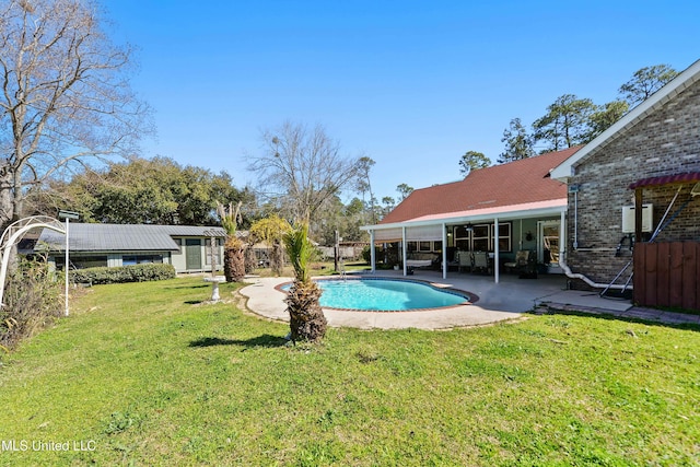 outdoor pool featuring a patio area and a lawn