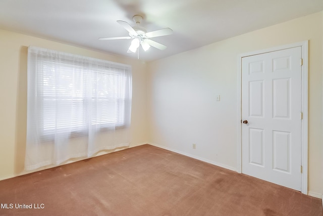 spare room with carpet, ceiling fan, and plenty of natural light