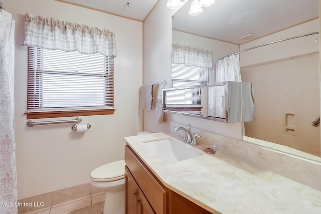 bathroom featuring vanity, tile patterned flooring, and toilet