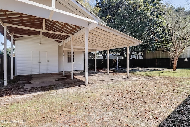 view of parking / parking lot featuring a carport