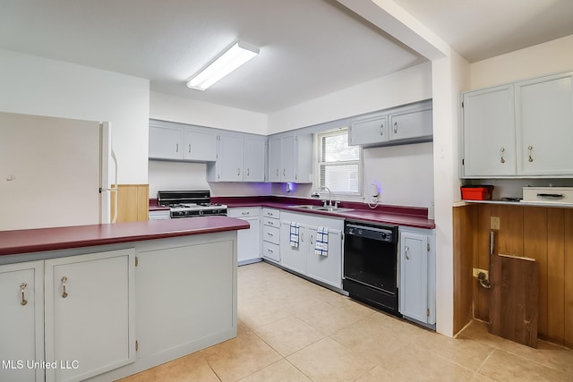 kitchen with gas stove, gray cabinetry, white refrigerator, black dishwasher, and sink