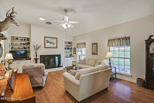 727 Laney Dr, Clinton, MS 39056 - living area with a ceiling fan, wood finished floors, built in features, a textured ceiling, and baseboards