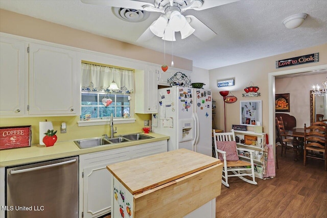 727 Laney Dr, Clinton, MS 39056 - kitchen featuring stainless steel dishwasher, white refrigerator with ice dispenser, a sink, ceiling fan, and white cabinetry