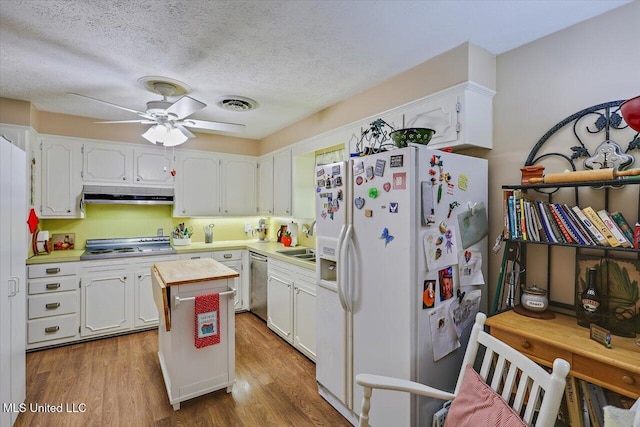 727 Laney Dr, Clinton, MS 39056 - kitchen featuring white refrigerator with ice dispenser, stainless steel dishwasher, under cabinet range hood, stovetop, and ceiling fan