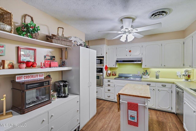 727 Laney Dr, Clinton, MS 39056 - kitchen featuring appliances with stainless steel finishes, a ceiling fan, light countertops, white cabinetry, and a textured ceiling