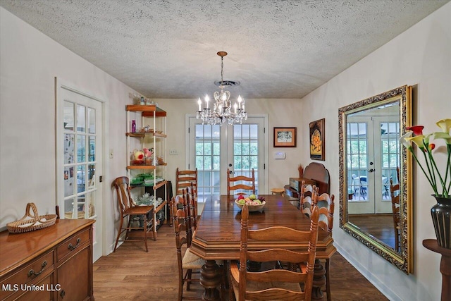 727 Laney Dr, Clinton, MS 39056 - dining space with french doors, a chandelier, a textured ceiling, dark wood-style floors, and healthy amount of natural light