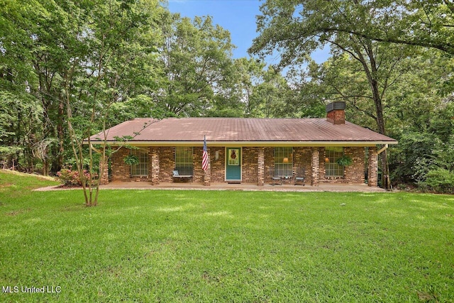 727 Laney Dr, Clinton, MS 39056 - view of front facade featuring a chimney, a front lawn, covered porch, and metal roof