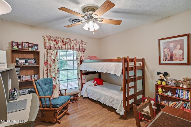 727 Laney Dr, Clinton, MS 39056 - bedroom featuring light wood-style floors, a textured ceiling, and ceiling fan