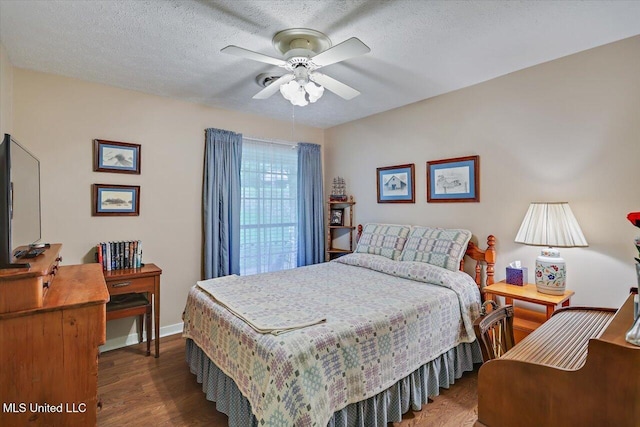 727 Laney Dr, Clinton, MS 39056 - bedroom with wood finished floors, a ceiling fan, baseboards, and a textured ceiling