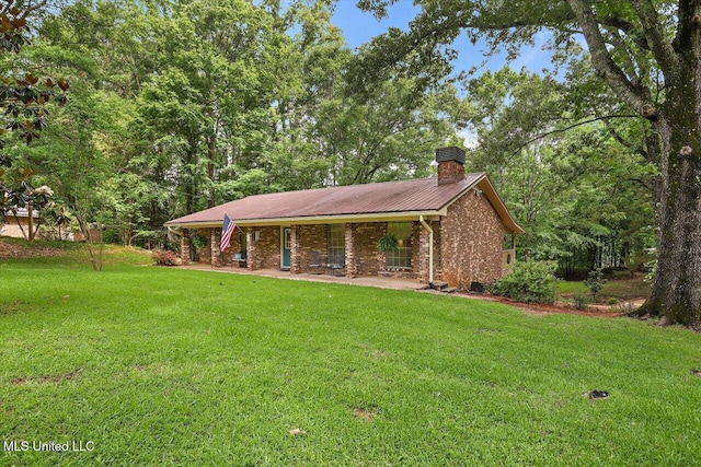 727 Laney Dr, Clinton, MS 39056 - single story home with a chimney, a front yard, metal roof, and brick siding