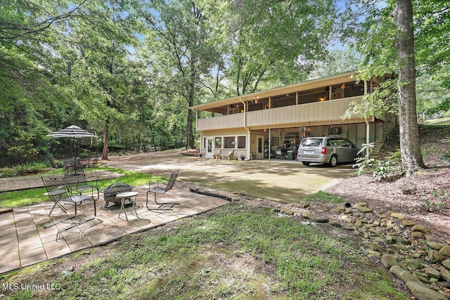 727 Laney Dr, Clinton, MS 39056 - rear view of house featuring a fire pit and a patio area