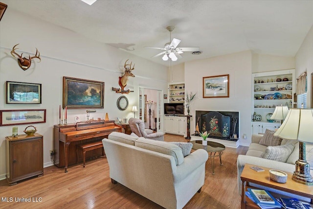 727 Laney Dr, Clinton, MS 39056 - living area featuring built in features, ceiling fan, light wood-style floors, and baseboards