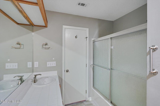 bathroom featuring vanity, a textured ceiling, and shower / bath combination with glass door