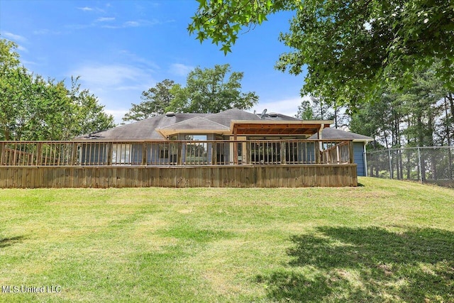 rear view of property with a yard and a deck