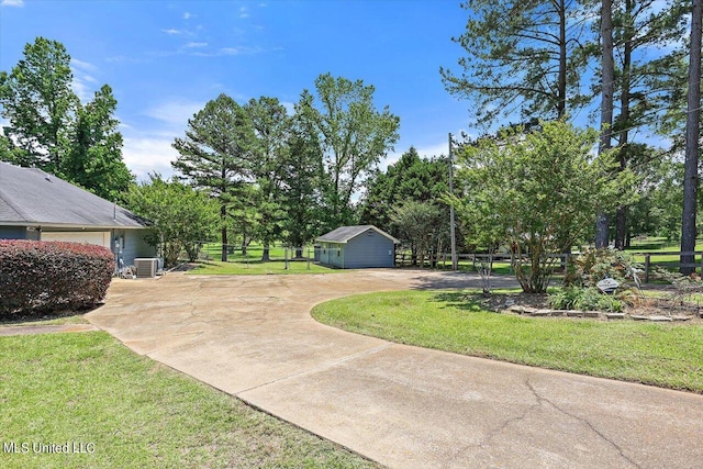 view of yard with an outdoor structure and central AC