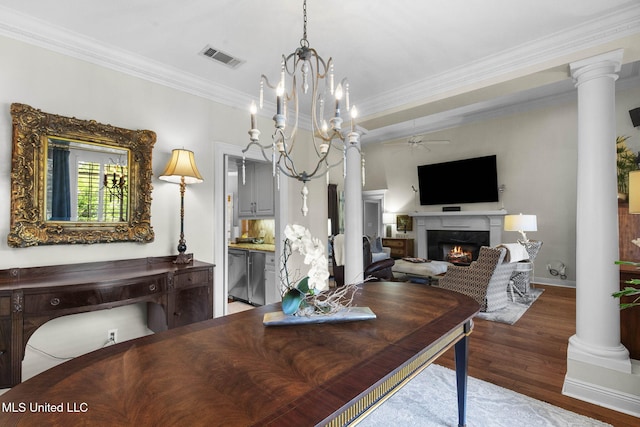 141 Whisper Lake Blvd, Madison, MS 39110 - dining area featuring a lit fireplace, wood finished floors, crown molding, ceiling fan, and decorative columns