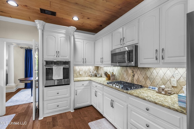 141 Whisper Lake Blvd, Madison, MS 39110 - kitchen with stainless steel appliances, ornate columns, wooden ceiling, dark wood-style floors, and white cabinetry