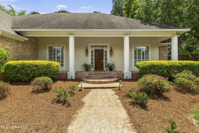 141 Whisper Lake Blvd, Madison, MS 39110 - entrance to property featuring a shingled roof, stucco siding, a porch, and brick siding