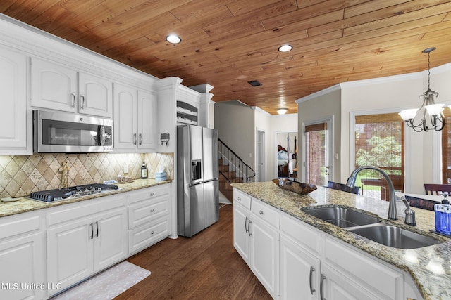 141 Whisper Lake Blvd, Madison, MS 39110 - kitchen featuring appliances with stainless steel finishes, wooden ceiling, a chandelier, white cabinets, and backsplash