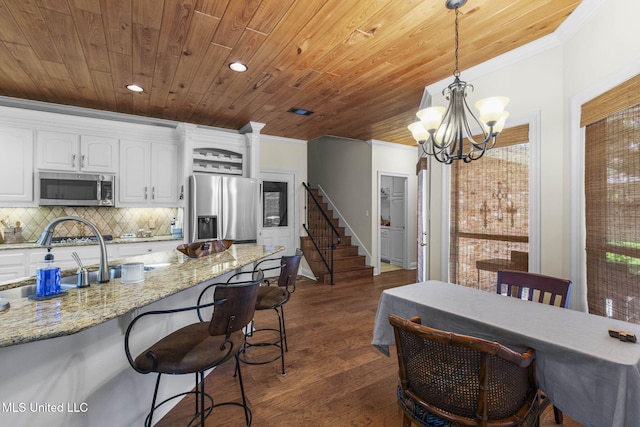 141 Whisper Lake Blvd, Madison, MS 39110 - kitchen featuring stainless steel appliances, ornamental molding, white cabinets, wooden ceiling, and pendant lighting