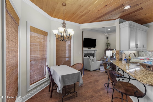 141 Whisper Lake Blvd, Madison, MS 39110 - dining area with wood ceiling, a chandelier, dark wood finished floors, ornamental molding, and ceiling fan