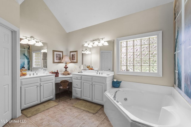141 Whisper Lake Blvd, Madison, MS 39110 - bathroom featuring lofted ceiling, healthy amount of natural light, vanity, a tub with jets, and tile patterned floors