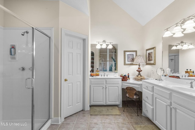141 Whisper Lake Blvd, Madison, MS 39110 - bathroom with lofted ceiling, a shower stall, two vanities, and tile patterned flooring