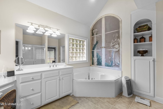 141 Whisper Lake Blvd, Madison, MS 39110 - full bath with vanity, a shower stall, a jetted tub, vaulted ceiling, and tile patterned flooring