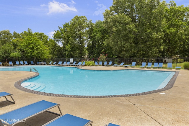 141 Whisper Lake Blvd, Madison, MS 39110 - community pool with a patio and view of wooded area
